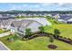 Beautiful aerial view of a home next to a pond, with professional landscaping and ample lawn space at 116 Glengrove Lane, Murrells Inlet, SC 29576