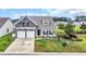 Charming two-story home with a two-car garage, stone accents, and a landscaped front yard at 116 Glengrove Lane, Murrells Inlet, SC 29576