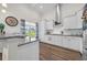 Modern kitchen featuring white cabinets, granite countertops, stainless steel appliances, and a window view at 116 Glengrove Lane, Murrells Inlet, SC 29576