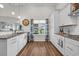 Bright kitchen with stainless steel appliances, granite countertops, white cabinetry, and a window overlooking the yard at 116 Glengrove Lane, Murrells Inlet, SC 29576