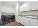 Laundry room features washer, dryer, ample cabinet space, and a utility sink at 116 Glengrove Lane, Murrells Inlet, SC 29576
