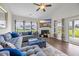 Inviting living area features a cozy fireplace, large windows, and stylish blue sectional with ample seating at 116 Glengrove Lane, Murrells Inlet, SC 29576