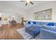 Open-concept living space with a large blue sectional, decorative mirror, and dining area in the background at 116 Glengrove Lane, Murrells Inlet, SC 29576