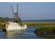 Fishing trawler in the marsh, illustrating the coastal lifestyle and maritime heritage of the area at 118 Westfield Circle, Conway, SC 29526