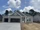 Newly built home with a spacious three car garage, featuring modern design and clean lines at 118 Westfield Circle, Conway, SC 29526