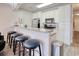 Bright kitchen boasts bar seating, stainless appliances, and crisp white cabinetry at 121 Waypoint Ridge Ave. # P-15, Little River, SC 29566