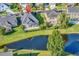 Aerial view of house features a backyard pond and established landscaping at 1210 East Isle Of Palms Ave., Myrtle Beach, SC 29579