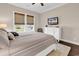 Bright bedroom featuring a striped comforter, woven blinds, and a white dresser at 1210 East Isle Of Palms Ave., Myrtle Beach, SC 29579