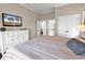 Bright bedroom features a dresser with a TV, a closet, and ensuite bathroom access at 1210 East Isle Of Palms Ave., Myrtle Beach, SC 29579