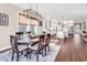 Open dining area with a dark wooden table, seating for six, and natural light from large windows at 1210 East Isle Of Palms Ave., Myrtle Beach, SC 29579