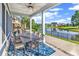 Covered outdoor patio features a dining table and seating with scenic pond views at 1210 East Isle Of Palms Ave., Myrtle Beach, SC 29579