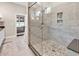 Modern walk-in shower with pebble floor and tile surround in the main bathroom at 1210 East Isle Of Palms Ave., Myrtle Beach, SC 29579
