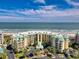 Stunning aerial view of an oceanfront condo complex featuring manicured grounds and a pristine beach at 135 S Dunes Dr. # 501, Pawleys Island, SC 29585