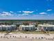 Aerial view of the beach with multiple resort buildings, landscaped grounds, and various pools at 135 S Dunes Dr. # 501, Pawleys Island, SC 29585