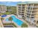 Aerial view of a beach resort complex with a swimming pool and sunbathing area surrounded by tall condo buildings at 135 S Dunes Dr. # 501, Pawleys Island, SC 29585