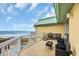 Balcony with seating and ocean views with the beach and a pool visible in the background at 135 S Dunes Dr. # 501, Pawleys Island, SC 29585