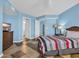 Comfortable bedroom with a rattan headboard, diagonally laid tile floor, and blue walls with white trim at 135 S Dunes Dr. # 501, Pawleys Island, SC 29585