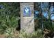 Stone entrance sign for Litchfield By The Sea surrounded by lush greenery and landscaping at 135 S Dunes Dr. # 501, Pawleys Island, SC 29585