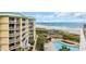 Exterior view featuring tall buildings with balconies and a swimming pool surrounded by manicured landscaping and beach access at 135 S Dunes Dr. # 501, Pawleys Island, SC 29585