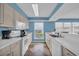 Well-equipped kitchen with white appliances and countertops, offering beautiful views at 135 S Dunes Dr. # 501, Pawleys Island, SC 29585