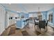 Open-concept kitchen with white cabinetry, bar seating, and a dining area with a view at 135 S Dunes Dr. # 501, Pawleys Island, SC 29585