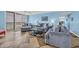 Comfortable living room with plush sofas, tile floors, and a balcony with ocean views at 135 S Dunes Dr. # 501, Pawleys Island, SC 29585