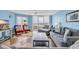 Bright living room featuring comfortable seating, sliding door access to a private balcony with beach views at 135 S Dunes Dr. # 501, Pawleys Island, SC 29585