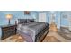 Comfortable bedroom with a queen-sized bed and en-suite bathroom access, featuring tile floors at 135 S Dunes Dr. # 501, Pawleys Island, SC 29585