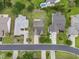 Aerial view of the home with driveway, manicured lawns, trees, and neighboring houses along the street at 15 Saltwind Loop, Murrells Inlet, SC 29576