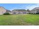 The backyard features a well-maintained lawn, concrete patio and view of neighboring homes at 15 Saltwind Loop, Murrells Inlet, SC 29576