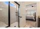 Modern bathroom with a tiled walk-in shower with a glass door and view of Primary bedroom at 15 Saltwind Loop, Murrells Inlet, SC 29576