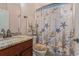 Bathroom with granite countertop, a decorative seashell shower curtain, and matching seashell-themed towels at 15 Saltwind Loop, Murrells Inlet, SC 29576
