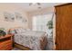 This bedroom features carpet floors, a wooden bed frame and dresser, and natural light from the windows at 15 Saltwind Loop, Murrells Inlet, SC 29576