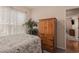 Cozy bedroom with neutral walls, carpet floors, an armoire and a large window with plantation shutters at 15 Saltwind Loop, Murrells Inlet, SC 29576