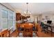 Inviting dining area with a wooden table set, views to kitchen and living areas, and natural light from a nearby window at 15 Saltwind Loop, Murrells Inlet, SC 29576