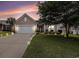 Charming single-story home with a well-manicured lawn, complemented by a large driveway and elegant exterior lighting at 15 Saltwind Loop, Murrells Inlet, SC 29576
