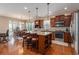 Open kitchen with dark cabinets, granite counters, stainless appliances, island and eating area at 15 Saltwind Loop, Murrells Inlet, SC 29576