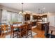 Bright eat-in kitchen with dark cabinets, granite counters, stainless appliances, island and hardwood flooring at 15 Saltwind Loop, Murrells Inlet, SC 29576