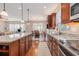 Spacious kitchen with dark cabinets, granite counters, stainless appliances, island and hardwood flooring at 15 Saltwind Loop, Murrells Inlet, SC 29576