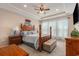 Main bedroom with a tray ceiling, ceiling fan, wood furniture and lots of natural light at 15 Saltwind Loop, Murrells Inlet, SC 29576