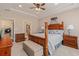 Comfortable main bedroom with a tray ceiling, ceiling fan, wood furniture, bench and carpet at 15 Saltwind Loop, Murrells Inlet, SC 29576