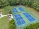 Aerial view of community pickleball courts with players, surrounded by green space and lush landscaping at 15 Saltwind Loop, Murrells Inlet, SC 29576