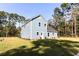 View of a two-story home featuring light blue siding, white trim, and a well-maintained lawn at 155 Mckenzie Circle, Pawleys Island, SC 29585