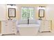 Luxurious bathroom with dual vanities, a freestanding tub, and a view of nature at 155 Mckenzie Circle, Pawleys Island, SC 29585