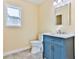 Well-lit bathroom featuring a blue vanity, white toilet, and a large mirror at 155 Mckenzie Circle, Pawleys Island, SC 29585