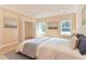Inviting bedroom with a neutral palette, hardwood floors, two windows, and a decorative bedspread at 155 Mckenzie Circle, Pawleys Island, SC 29585