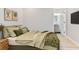 Cozy bedroom with soft green tones and natural lighting, plus a sneak peek to the adjacent bathroom at 155 Mckenzie Circle, Pawleys Island, SC 29585