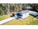 Charming two-story home featuring an attached garage, a welcoming front porch, and well-manicured lawn at 155 Mckenzie Circle, Pawleys Island, SC 29585