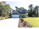 Charming two-story home with blue siding, white trim, and a spacious two-car garage at 155 Mckenzie Circle, Pawleys Island, SC 29585