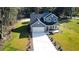 Inviting two-story home featuring a long driveway, attached garage, and a charming front porch at 155 Mckenzie Circle, Pawleys Island, SC 29585